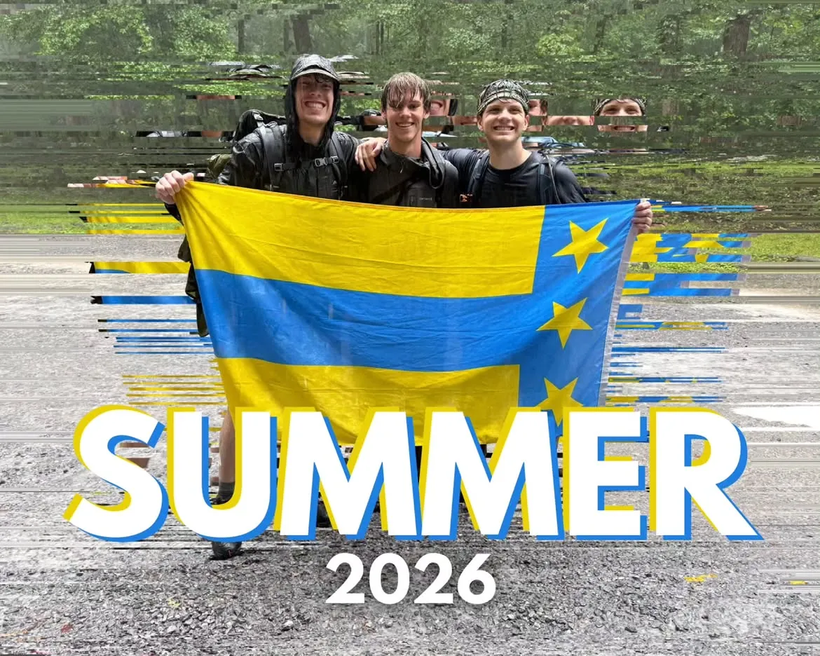 Three brothers holding a flag outdoors in the rain, a Summer 2026 trip graphic