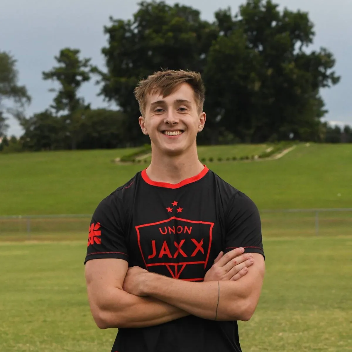 Philip Avery smiling outdoors on the intramural field